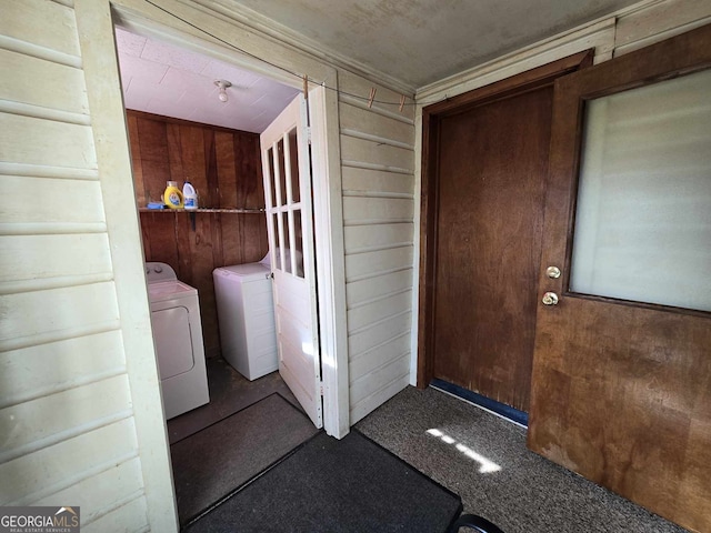 view of exterior entry featuring washing machine and dryer