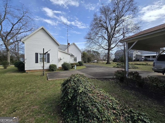 view of side of property with a lawn