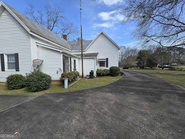 view of property exterior featuring a chimney