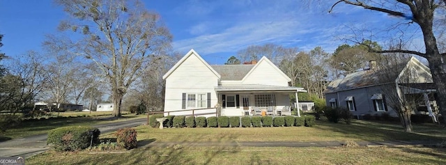 view of front facade with a porch and a front lawn