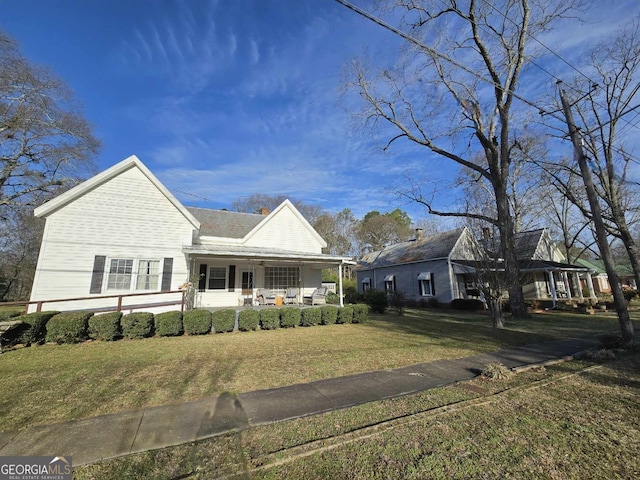 view of front of home featuring covered porch and a front yard