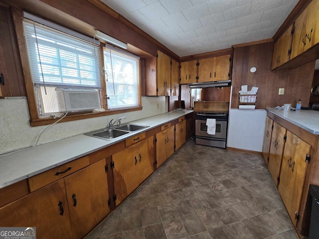 kitchen featuring brown cabinets, stainless steel electric stove, light countertops, under cabinet range hood, and a sink