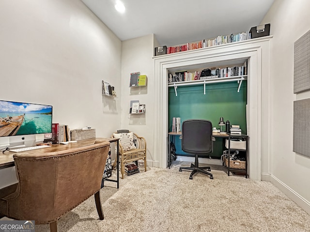 carpeted home office featuring baseboards