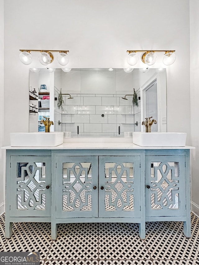 full bath featuring a tile shower and vanity