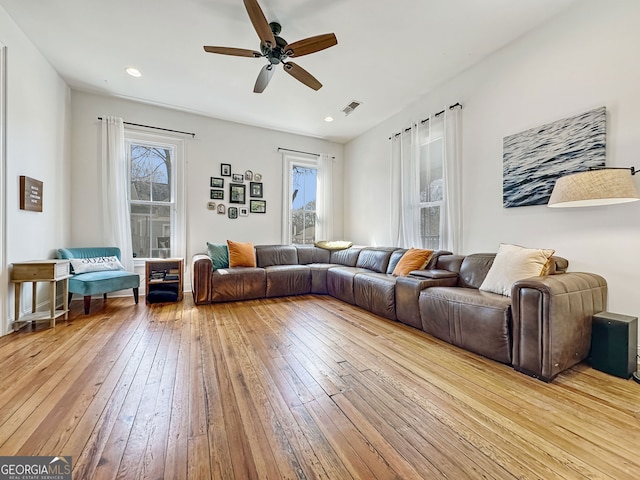 living area with a ceiling fan, recessed lighting, visible vents, and hardwood / wood-style floors