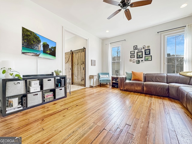 living area featuring a ceiling fan, recessed lighting, plenty of natural light, and light wood-style flooring