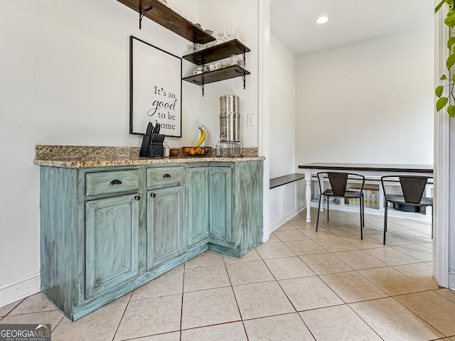 bar featuring light tile patterned flooring and baseboards