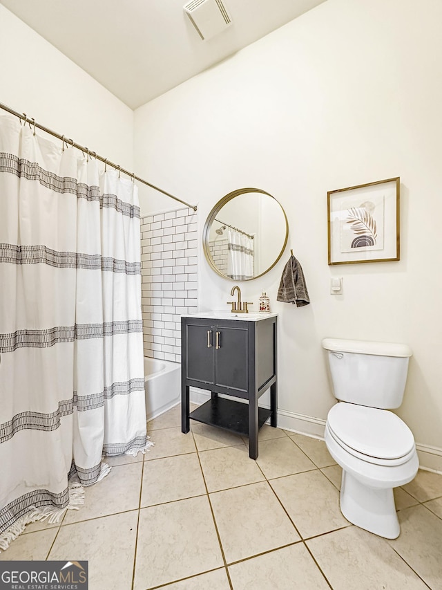 bathroom featuring tile patterned flooring, toilet, vanity, visible vents, and shower / bath combo with shower curtain