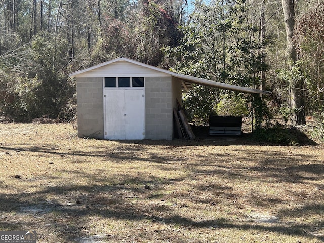 view of shed with a forest view