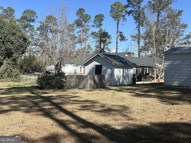 view of side of property featuring a yard and fence