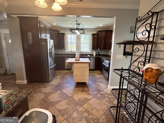 kitchen featuring a kitchen island, crown molding, dark brown cabinetry, appliances with stainless steel finishes, and a notable chandelier