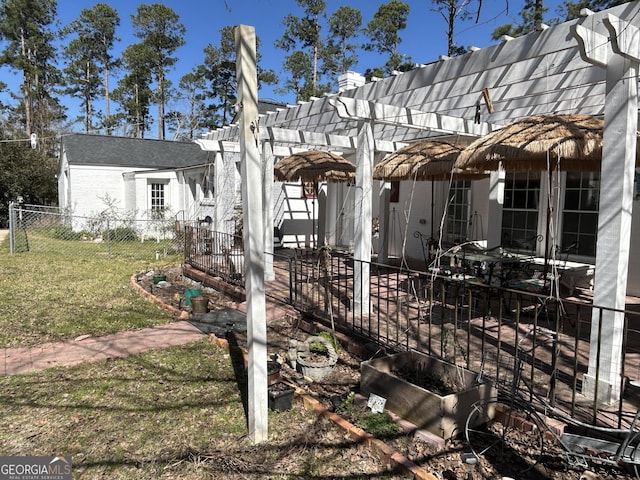 view of side of home with a patio, a yard, fence, and a pergola