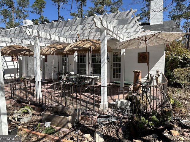 rear view of house featuring a chimney, a patio, and a pergola