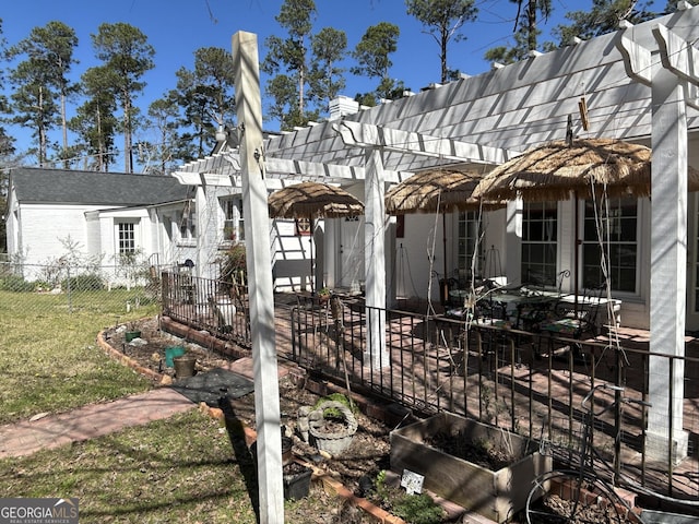 view of side of property with a yard, a pergola, a patio, and fence