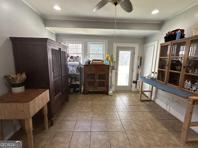 entrance foyer with ceiling fan, plenty of natural light, light tile patterned flooring, and crown molding