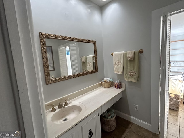 bathroom with vanity, tile patterned floors, and baseboards