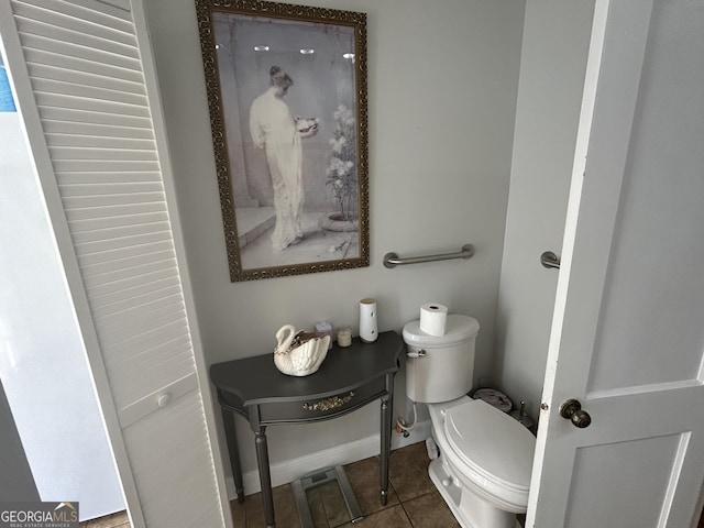 bathroom with tile patterned flooring, toilet, and baseboards