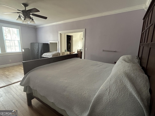 bedroom featuring crown molding, wood finished floors, baseboards, and ceiling fan