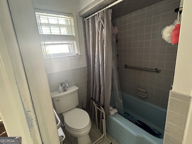 bathroom featuring a wainscoted wall, toilet, tile walls, and shower / bath combination with curtain