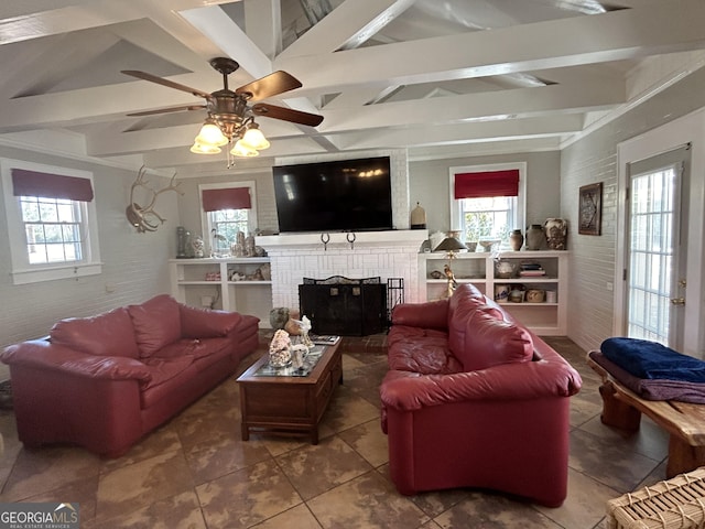 living area with beam ceiling, a healthy amount of sunlight, and a fireplace