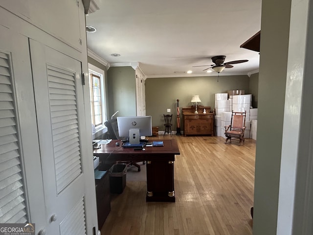 office featuring a ceiling fan, wood finished floors, and ornamental molding