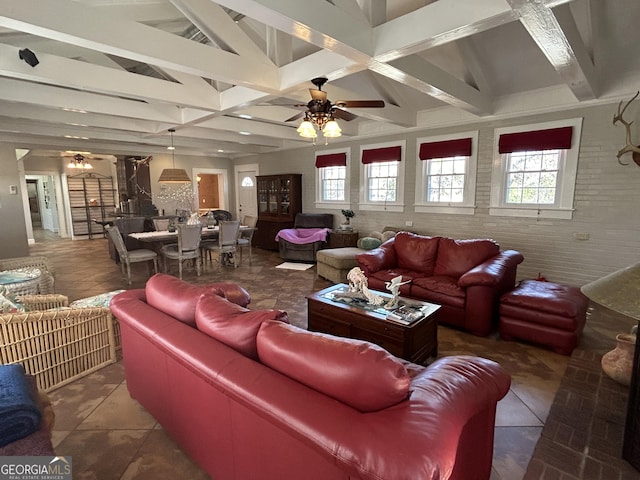 living room with beam ceiling, brick wall, and a ceiling fan