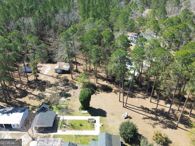 birds eye view of property featuring a view of trees