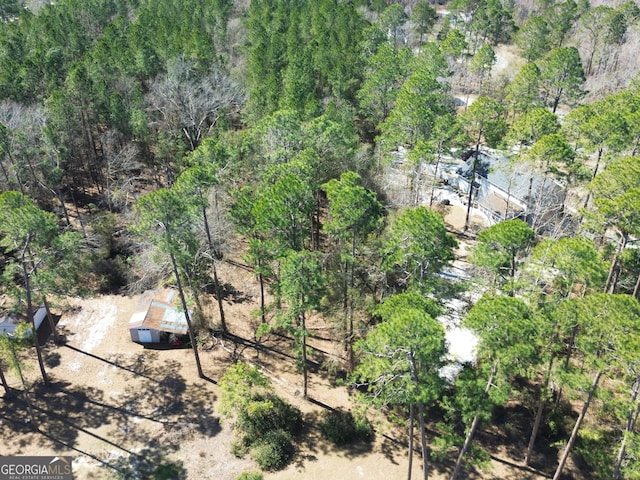 birds eye view of property featuring a view of trees