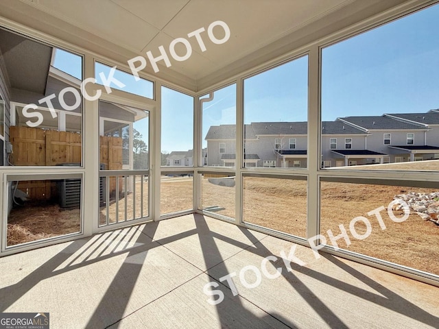 sunroom / solarium featuring a residential view