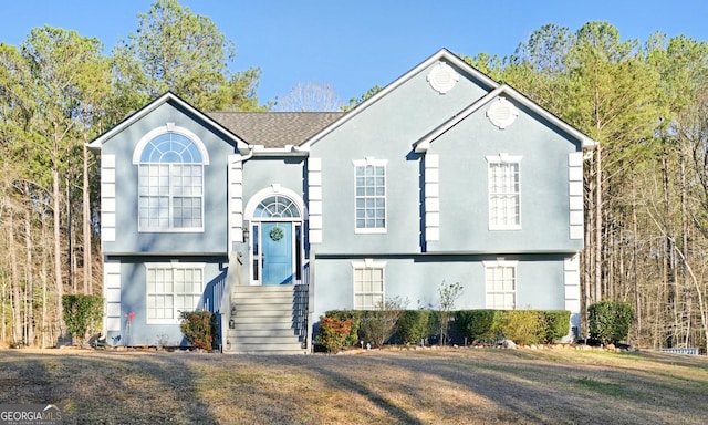 bi-level home with stucco siding