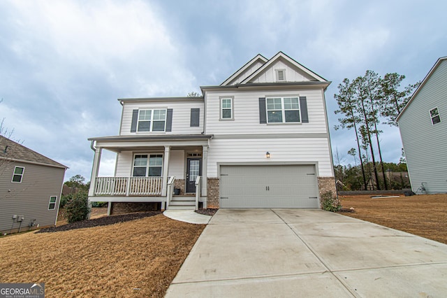 craftsman-style home with driveway, an attached garage, covered porch, board and batten siding, and brick siding