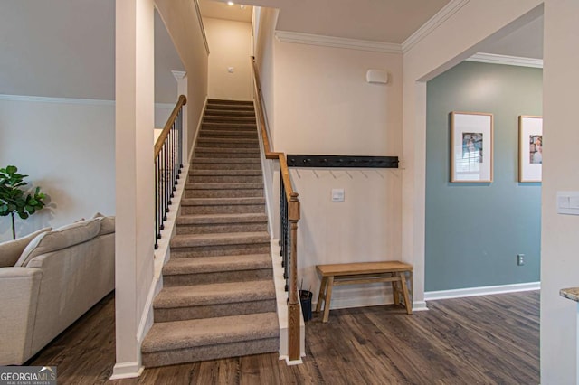 stairs with ornamental molding, baseboards, and wood finished floors