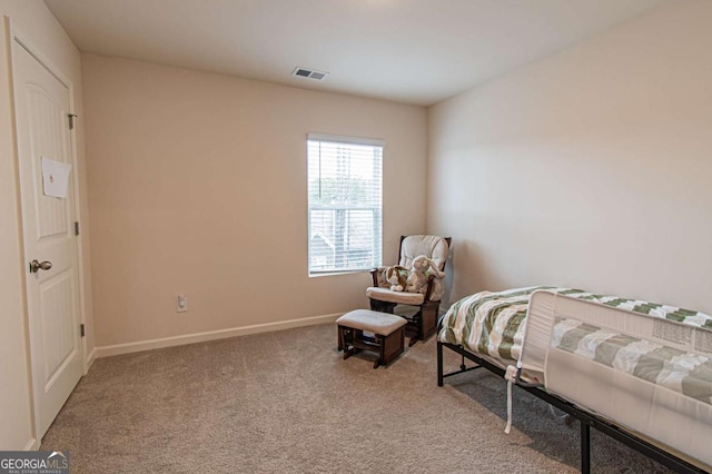 bedroom with baseboards, visible vents, and carpet flooring