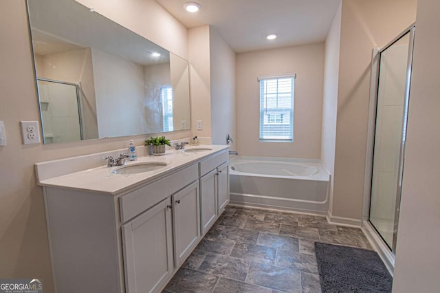 full bath featuring a stall shower, a garden tub, a sink, and double vanity