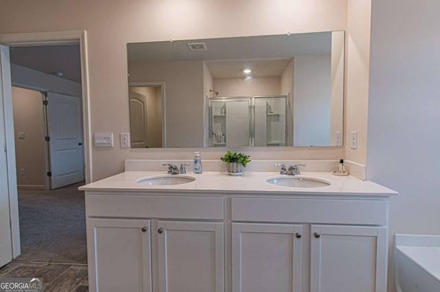 full bath featuring a stall shower, a sink, a bath, and double vanity