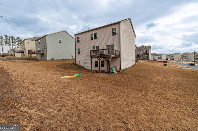 back of house with a residential view and a deck