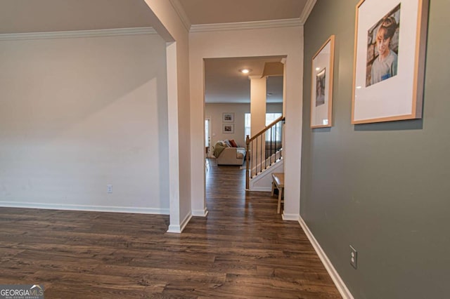 corridor with ornamental molding, dark wood-style flooring, stairway, and baseboards