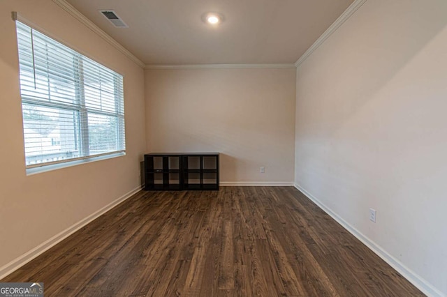 unfurnished room featuring ornamental molding, visible vents, baseboards, and dark wood-style floors