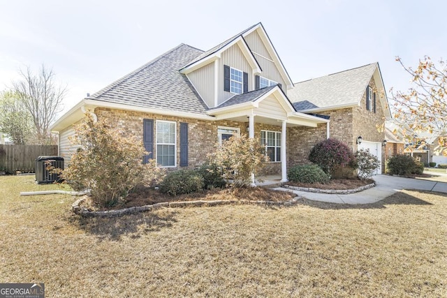 view of front of house featuring cooling unit, a shingled roof, fence, concrete driveway, and a front lawn