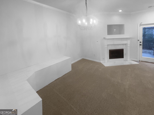 unfurnished living room featuring carpet flooring, crown molding, a fireplace with flush hearth, and an inviting chandelier