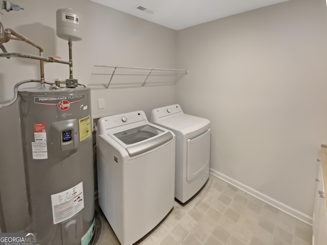 laundry room featuring visible vents, independent washer and dryer, electric water heater, baseboards, and laundry area