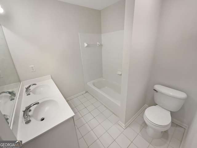 bathroom featuring a sink, toilet, double vanity, and tile patterned floors