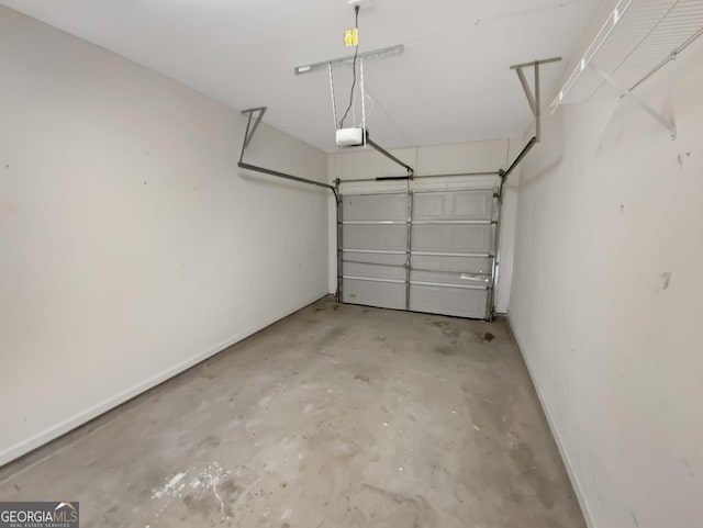 garage with a garage door opener and baseboards