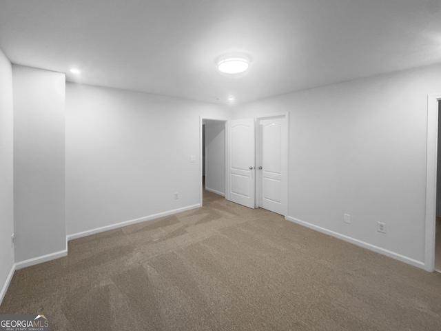 spare room with recessed lighting, carpet, and baseboards