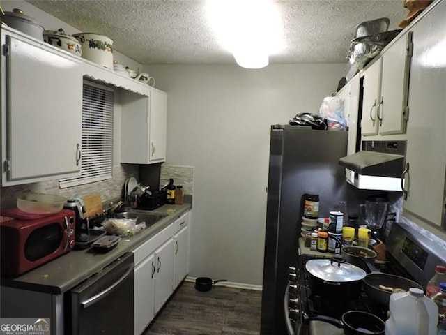 kitchen with white cabinets, dark wood finished floors, decorative backsplash, ventilation hood, and a sink