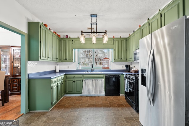 kitchen with decorative backsplash, hanging light fixtures, a notable chandelier, black appliances, and a sink