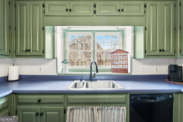 kitchen featuring green cabinetry, decorative backsplash, black dishwasher, and a sink