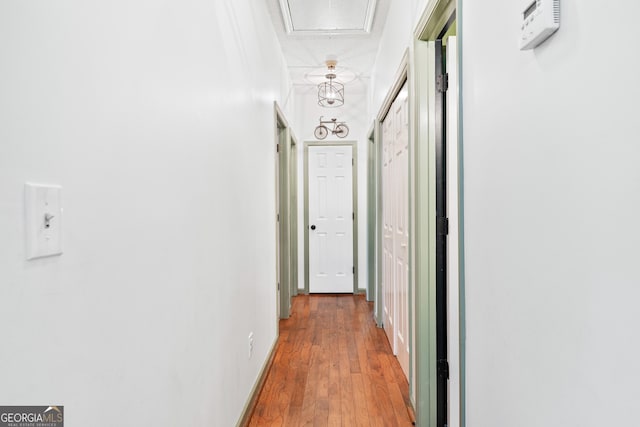 hall with wood finished floors and baseboards