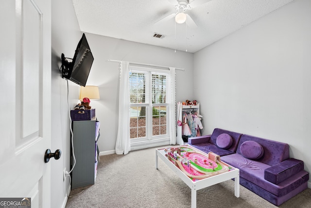 playroom with baseboards, carpet, visible vents, and a textured ceiling