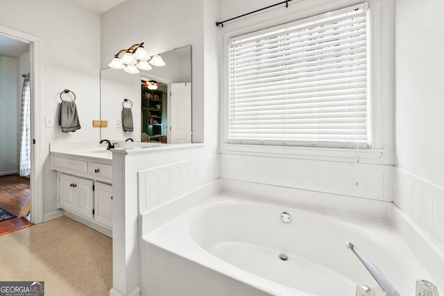 bathroom featuring vanity and a bath